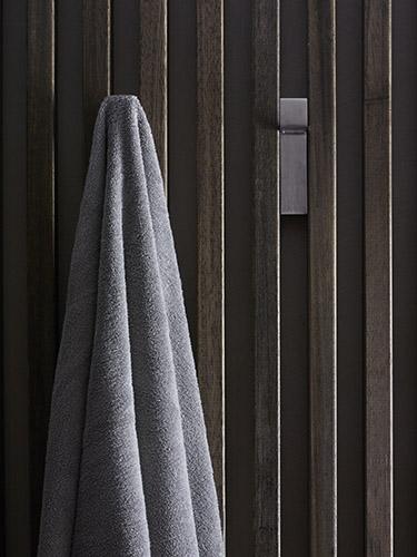 Wooden wall with hooks and towel