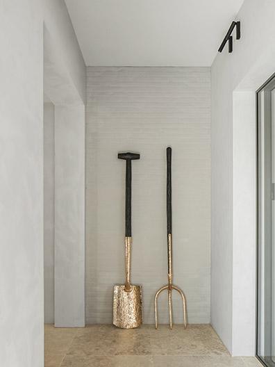 Gold and black fork and spade art in hallway at office in Brabant, Netherlands