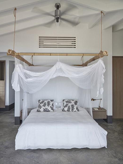 Bedroom with bed and mosquito net at beach villa on Bonaire